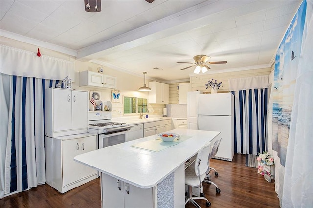 4329 Park St, Acworth, GA 30101 - kitchen with white appliances, ornamental molding, ceiling fan, a center island, and dark wood-style flooring