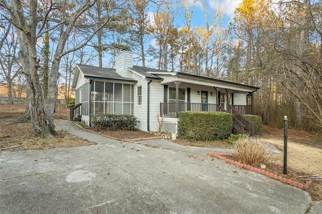 view of front of property with covered porch and a sunroom