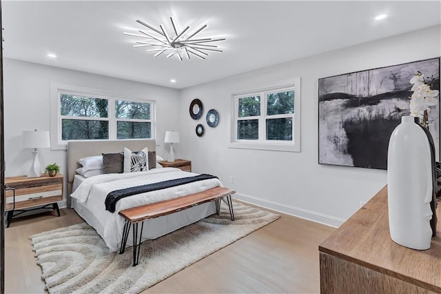 bedroom featuring recessed lighting, multiple windows, baseboards, and wood finished floors