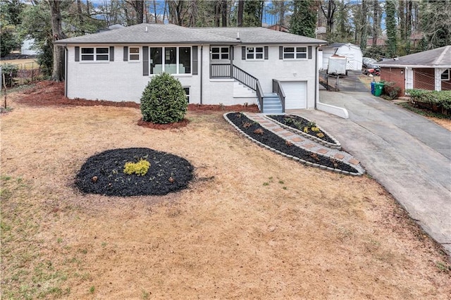 single story home with driveway and an attached garage