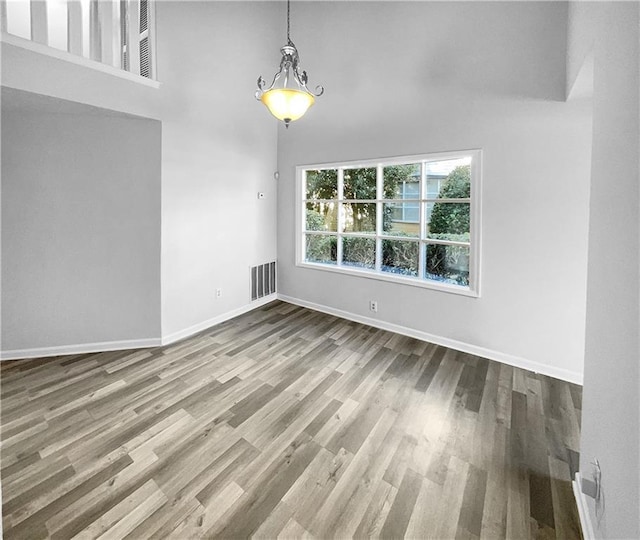 unfurnished room with wood-type flooring