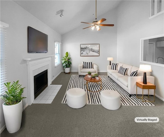 carpeted living room with lofted ceiling, ceiling fan, and a fireplace