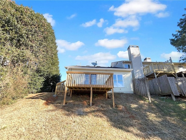 rear view of property featuring a wooden deck