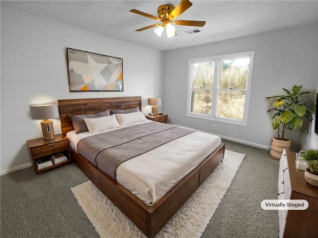 bedroom with ceiling fan and dark carpet