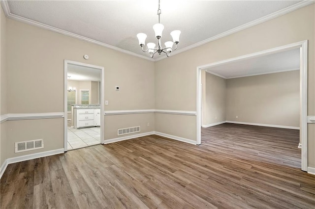 2004 Township Dr, Woodstock, GA 30189 - spare room with a chandelier, wood finished floors, and crown molding