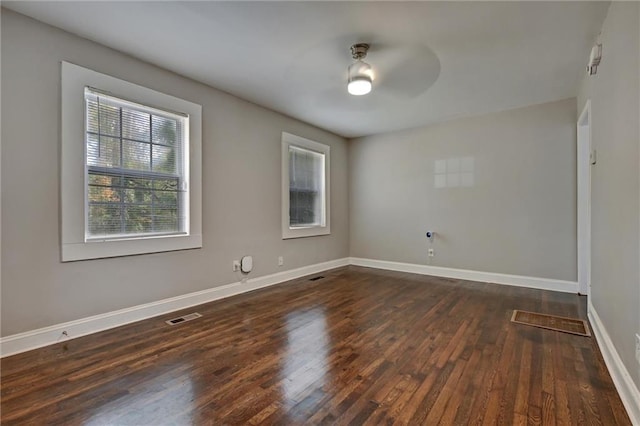 unfurnished room with ceiling fan and dark wood-type flooring