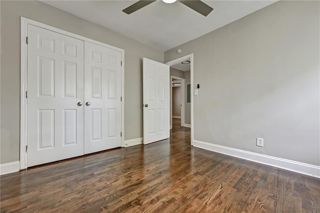 unfurnished bedroom with ceiling fan, dark wood-type flooring, and a closet