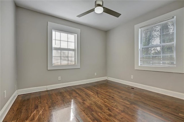 empty room with ceiling fan and dark hardwood / wood-style floors