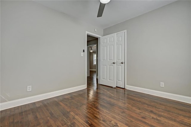 empty room featuring ceiling fan and dark wood-type flooring