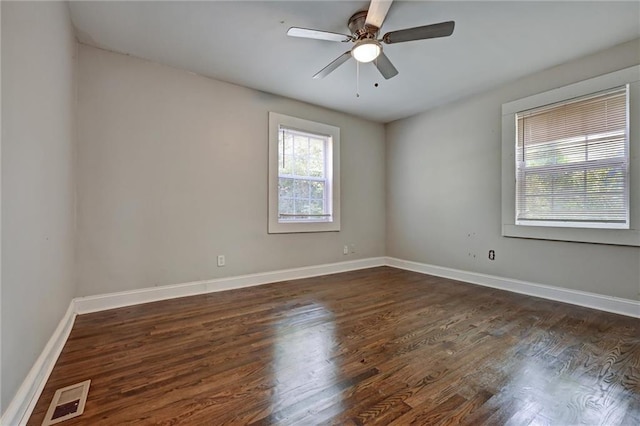 spare room with dark hardwood / wood-style floors and ceiling fan