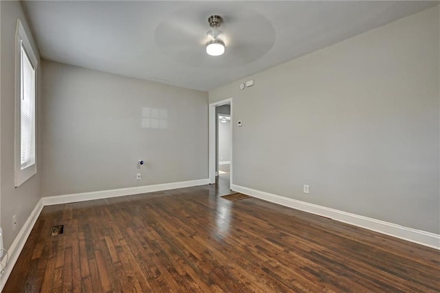 empty room with ceiling fan and dark hardwood / wood-style floors