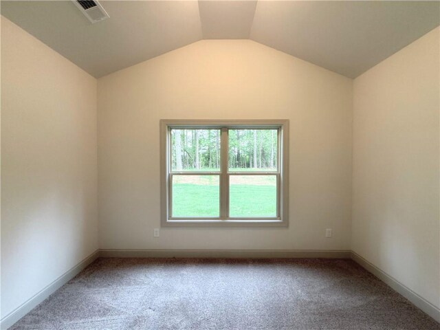 121 Honey Creek Rd, Conyers, GA 30094 - unfurnished room featuring visible vents, lofted ceiling, baseboards, and carpet flooring
