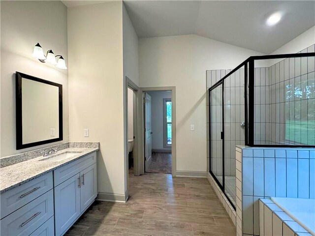 121 Honey Creek Rd, Conyers, GA 30094 - full bath with vanity, wood finished floors, lofted ceiling, a shower stall, and toilet
