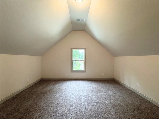 121 Honey Creek Rd, Conyers, GA 30094 - additional living space featuring visible vents, carpet floors, baseboards, and vaulted ceiling