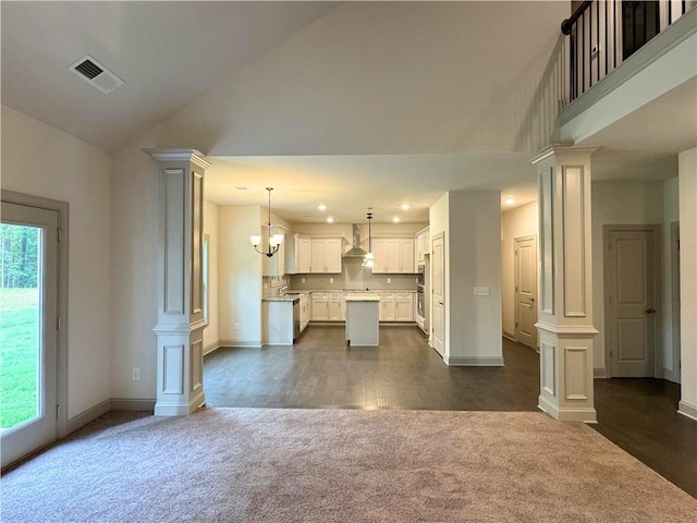 121 Honey Creek Rd, Conyers, GA 30094 - unfurnished living room featuring visible vents, plenty of natural light, dark colored carpet, and decorative columns