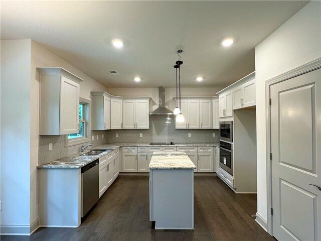 121 Honey Creek Rd, Conyers, GA 30094 - kitchen with visible vents, a sink, a kitchen island, stainless steel appliances, and wall chimney exhaust hood