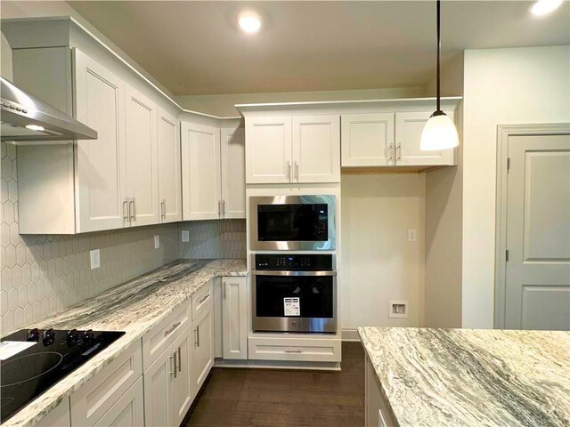 121 Honey Creek Rd, Conyers, GA 30094 - kitchen with light stone counters, wall chimney exhaust hood, backsplash, and stainless steel appliances