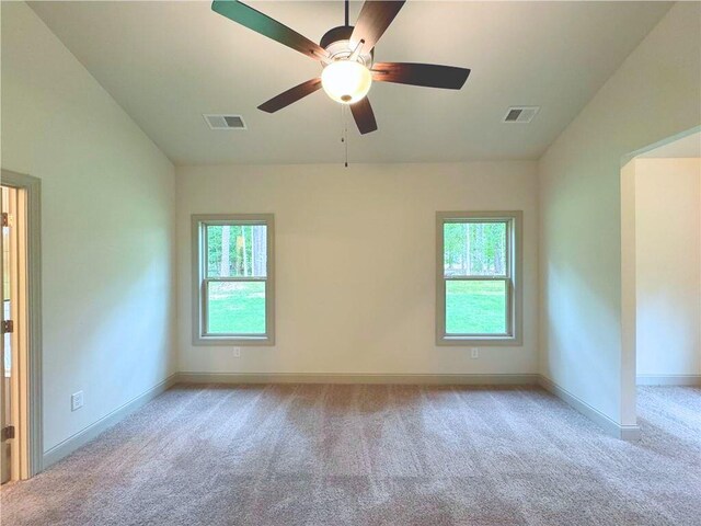 121 Honey Creek Rd, Conyers, GA 30094 - empty room with visible vents, plenty of natural light, and carpet
