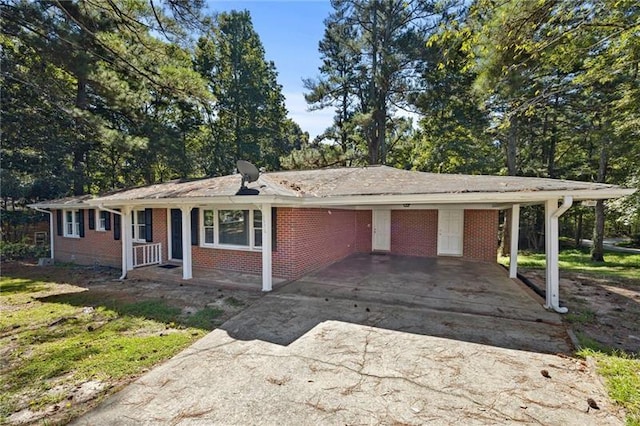 single story home with covered porch and a carport