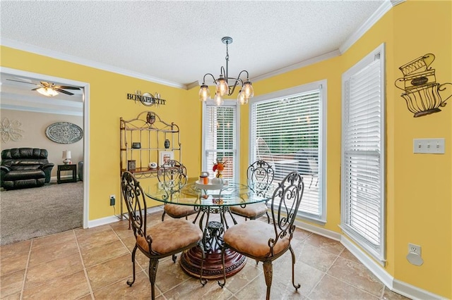 dining room featuring light tile patterned flooring, a textured ceiling, crown molding, and baseboards