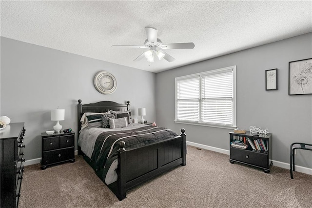 carpeted bedroom with a ceiling fan, baseboards, and a textured ceiling