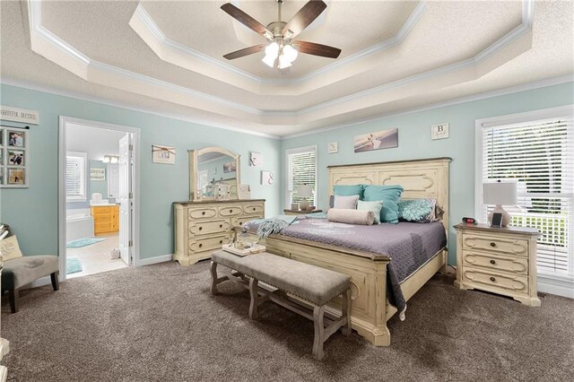 bedroom featuring carpet flooring, a textured ceiling, and a raised ceiling