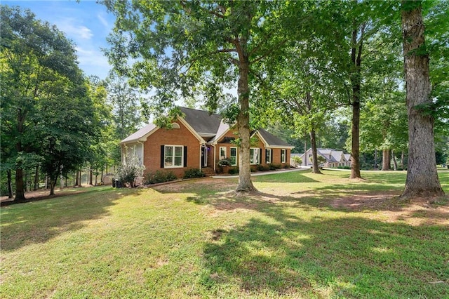 view of front of home featuring a front yard and brick siding