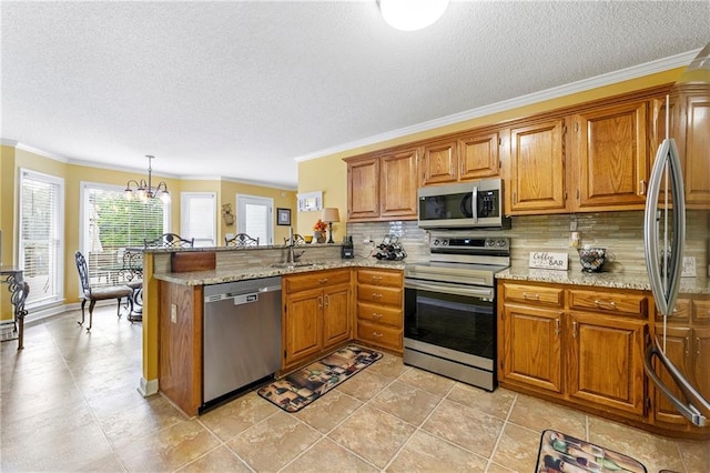 kitchen with a peninsula, backsplash, brown cabinets, and appliances with stainless steel finishes