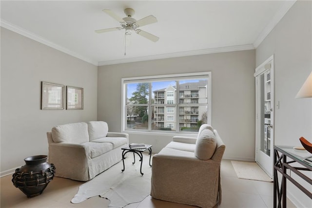 living room with ornamental molding and a ceiling fan