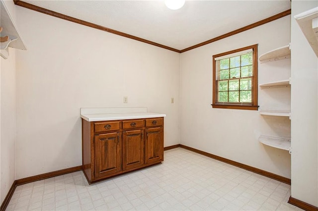 empty room with baseboards, ornamental molding, and light flooring