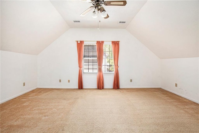 additional living space featuring light carpet, a ceiling fan, lofted ceiling, and baseboards