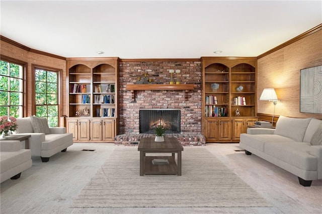 living room with crown molding, built in shelves, carpet floors, and a fireplace