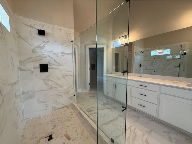 full bath featuring marble finish floor, a marble finish shower, and vanity