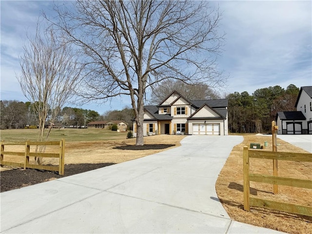 modern farmhouse style home featuring driveway, a garage, fence, and a front lawn