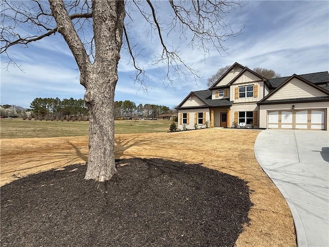 view of front of home featuring board and batten siding, a front yard, concrete driveway, and an attached garage