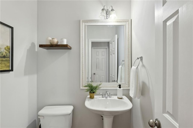 bathroom featuring toilet and sink