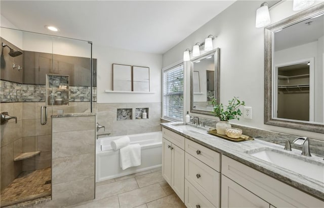 bathroom featuring tile patterned floors, separate shower and tub, and vanity