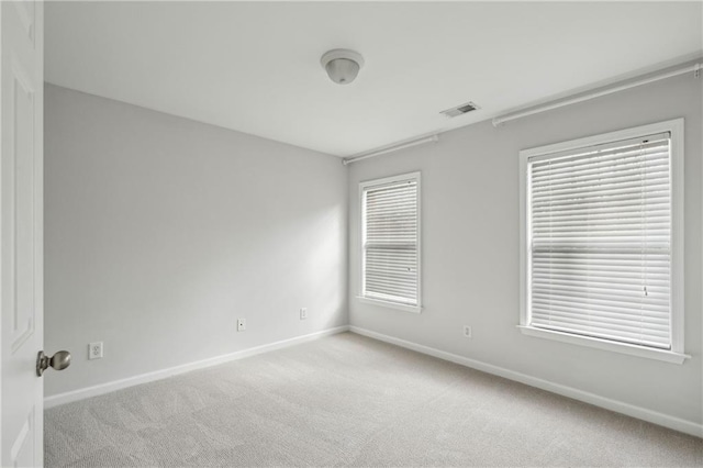 empty room featuring light colored carpet