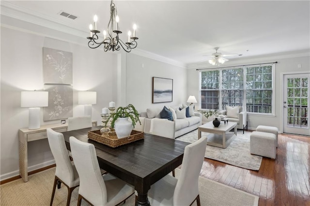 dining area featuring crown molding, light hardwood / wood-style flooring, and ceiling fan with notable chandelier