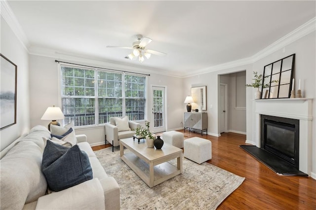 living room with crown molding, ceiling fan, and wood-type flooring