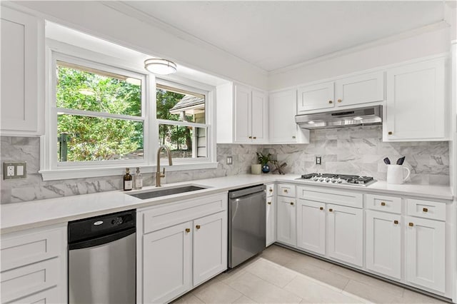 220 Hollyridge Dr, Roswell, GA 30076 - kitchen with appliances with stainless steel finishes, under cabinet range hood, backsplash, white cabinetry, and crown molding
