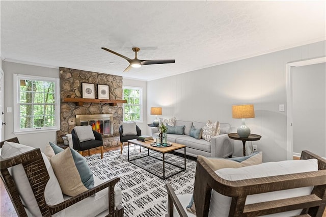 220 Hollyridge Dr, Roswell, GA 30076 - living area featuring crown molding, a stone fireplace, a ceiling fan, a textured ceiling, and wood finished floors