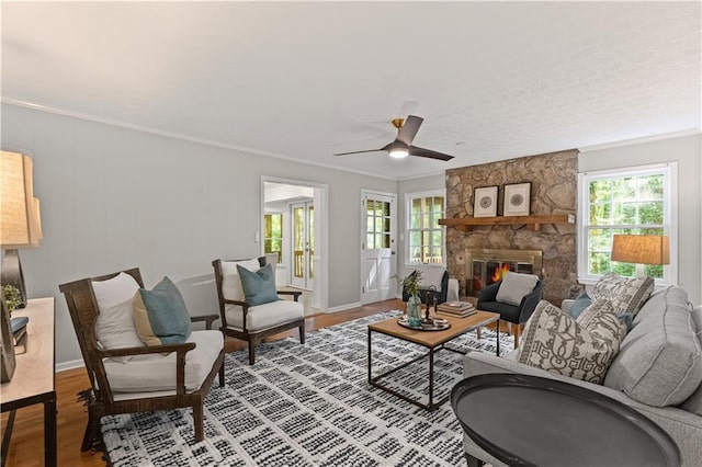 220 Hollyridge Dr, Roswell, GA 30076 - living room featuring plenty of natural light, wood finished floors, a ceiling fan, a fireplace, and crown molding