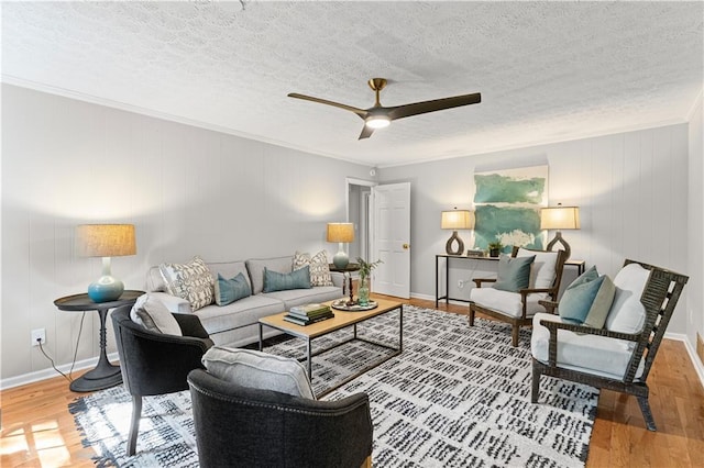 220 Hollyridge Dr, Roswell, GA 30076 - living area with a ceiling fan, wood finished floors, a textured ceiling, and ornamental molding