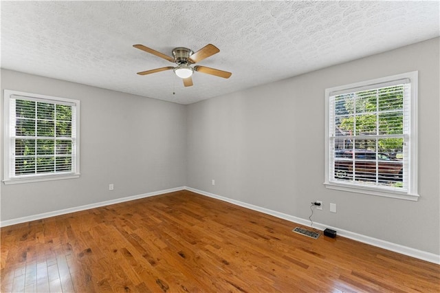 220 Hollyridge Dr, Roswell, GA 30076 - unfurnished room featuring healthy amount of natural light, wood finished floors, a ceiling fan, and a textured ceiling
