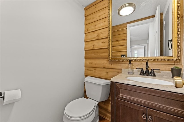220 Hollyridge Dr, Roswell, GA 30076 - half bathroom featuring vanity and wood walls