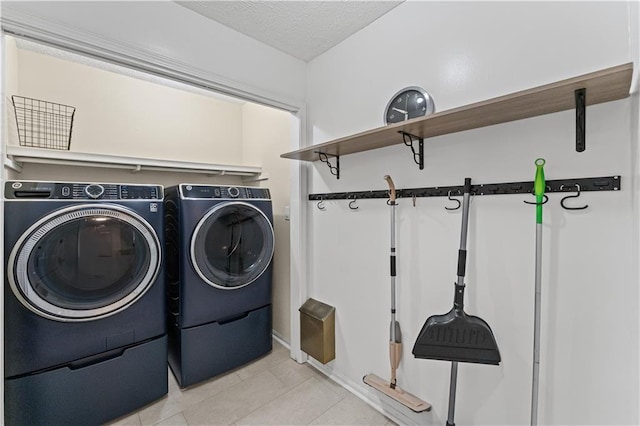 220 Hollyridge Dr, Roswell, GA 30076 - washroom featuring washer and clothes dryer, light tile patterned floors, and a textured ceiling