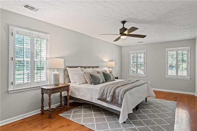 220 Hollyridge Dr, Roswell, GA 30076 - bedroom featuring wood finished floors, a textured ceiling, and ceiling fan