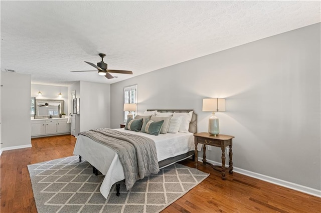 220 Hollyridge Dr, Roswell, GA 30076 - bedroom with a textured ceiling, wood finished floors, a ceiling fan, and ensuite bathroom