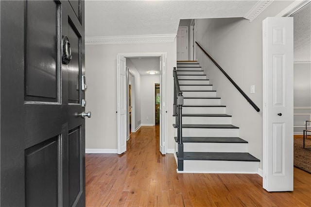 220 Hollyridge Dr, Roswell, GA 30076 - stairway with wood finished floors, crown molding, a textured ceiling, and attic access